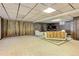 Large basement featuring unique wall designs, carpeted floors, and seating area at 3561 Kalispell St, Aurora, CO 80011