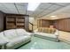 Spacious finished basement with wood paneling and a cozy seating area for entertaining at 3561 Kalispell St, Aurora, CO 80011