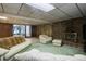 Large finished basement featuring a stone fireplace and sliding doors for easy outdoor access at 3561 Kalispell St, Aurora, CO 80011