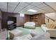 Finished basement with wood paneling, plush seating, and entertainment space for Gathering fun at 3561 Kalispell St, Aurora, CO 80011