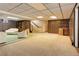 Spacious basement with carpeting, comfortable seating area, and stairway access at 3561 Kalispell St, Aurora, CO 80011