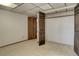 Basement featuring dark wood trim, carpet flooring and closet at 3561 Kalispell St, Aurora, CO 80011