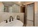 Bathroom featuring tile surround, block glass, and door to separate area at 3561 Kalispell St, Aurora, CO 80011