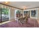 Bright dining room featuring hardwood floors, large windows, and access to an outdoor balcony at 3561 Kalispell St, Aurora, CO 80011