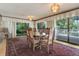 Elegant dining room with large windows overlooking the outdoors, creating a serene atmosphere at 3561 Kalispell St, Aurora, CO 80011