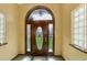 Elegant foyer featuring a wooden door with decorative glass and a transom window at 3561 Kalispell St, Aurora, CO 80011