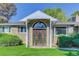 Close-up of the arched wooden front door with sidelights and a covered porch at 3561 Kalispell St, Aurora, CO 80011