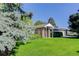 Charming brick home with well-manicured lawn and mature trees, enhancing curb appeal at 3561 Kalispell St, Aurora, CO 80011