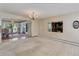 Spacious living room showcasing a view to the dining area with natural light and neutral decor at 3561 Kalispell St, Aurora, CO 80011