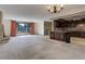 Inviting living room with a kitchen, fireplace, and large windows, providing ample natural light at 3561 Kalispell St, Aurora, CO 80011