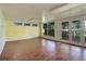 Bright living room with large windows and glass doors to the backyard with tile flooring and unique wall accents at 3561 Kalispell St, Aurora, CO 80011