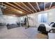 Unfinished basement area with gym setup and sleeping area at 5385 Walden Ct, Denver, CO 80249