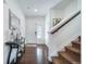 Bright entryway with console table, mirror, and staircase at 5385 Walden Ct, Denver, CO 80249