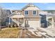 Two-story house with beige and brown siding, attached garage, and landscaping at 5385 Walden Ct, Denver, CO 80249