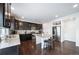 Modern kitchen with dark cabinets, granite counters, and stainless steel appliances at 5385 Walden Ct, Denver, CO 80249