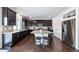 Modern kitchen with dark wood cabinets and granite island at 5385 Walden Ct, Denver, CO 80249