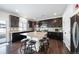 Modern kitchen with dark cabinets, granite counters, and an island at 5385 Walden Ct, Denver, CO 80249