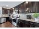 Modern kitchen with dark cabinetry and granite countertops at 5385 Walden Ct, Denver, CO 80249