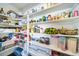 Well-stocked pantry with ample shelving for storage at 5385 Walden Ct, Denver, CO 80249