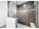 Large walk-in shower with tiled walls and seat at 5385 Walden Ct, Denver, CO 80249