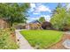 Back yard with lush lawn, brick garage and a playset at 3334 W 37Th Ave, Denver, CO 80211