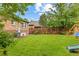 Back yard featuring a lush green lawn, mature trees, and playset at 3334 W 37Th Ave, Denver, CO 80211