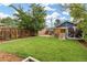Back yard featuring a lush green lawn, garage and playhouse at 3334 W 37Th Ave, Denver, CO 80211