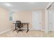 Basement office space featuring a black desk, office chair, and closet with mirrored doors at 3334 W 37Th Ave, Denver, CO 80211