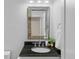 Elegant bathroom featuring a black granite countertop, framed mirror, and modern fixtures at 3334 W 37Th Ave, Denver, CO 80211