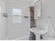 Bathroom with white tile, a pedestal sink, a shower-tub combination and decorative shower curtain at 3334 W 37Th Ave, Denver, CO 80211