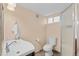 Neutral bathroom featuring a white sink, toilet, and glass shower stall with tiled flooring at 3334 W 37Th Ave, Denver, CO 80211