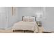 Bedroom featuring a black bed frame, white bedding, light-colored carpet, and side table at 3334 W 37Th Ave, Denver, CO 80211
