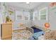bedroom featuring a crib, hardwood floors with area rug and windows offering great light at 3334 W 37Th Ave, Denver, CO 80211