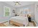 Bright bedroom featuring neutral decor, ceiling fan, and hardwood floors with a light-colored area rug at 3334 W 37Th Ave, Denver, CO 80211