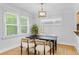 Charming dining room featuring a modern light fixture, bright windows, and stylish decor at 3334 W 37Th Ave, Denver, CO 80211