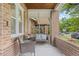 Inviting front porch with brick columns and comfortable seating, creating a cozy outdoor space at 3334 W 37Th Ave, Denver, CO 80211