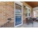 Close-up of the front door and sidelight from the front porch with seating at 3334 W 37Th Ave, Denver, CO 80211