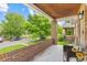 Inviting front porch with brick columns and wood ceiling, perfect for relaxing outdoors at 3334 W 37Th Ave, Denver, CO 80211