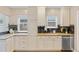 Bright kitchen featuring granite countertops, black backsplash, white cabinetry and stainless appliances at 3334 W 37Th Ave, Denver, CO 80211