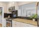 Kitchen with granite countertops, gas range, black backsplash, and stainless steel appliances at 3334 W 37Th Ave, Denver, CO 80211