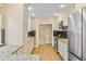 Well-lit kitchen featuring stainless steel appliances, granite countertops, and sleek black backsplash at 3334 W 37Th Ave, Denver, CO 80211