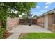 Back patio surrounded by green grass and brick exterior at 3334 W 37Th Ave, Denver, CO 80211