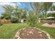 Spacious backyard with a well-manicured lawn, gazebo, mature trees, and patio seating area, perfect for entertaining at 7075 Welch Ct, Arvada, CO 80004