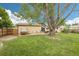 Backyard featuring mature trees, lawn, patio area, and relaxing hot tub, perfect for outdoor enjoyment and entertainment at 7075 Welch Ct, Arvada, CO 80004