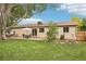 Expansive backyard featuring a patio dining area, a lush lawn, and a hot tub at 7075 Welch Ct, Arvada, CO 80004