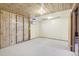 Partially finished basement with wood paneling, a drop ceiling, and concrete floors offering customization potential at 7075 Welch Ct, Arvada, CO 80004