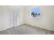 Bright bedroom featuring a large window with neighborhood views and a spacious closet at 7075 Welch Ct, Arvada, CO 80004