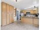 Spacious kitchen featuring stainless steel appliances, granite countertops, and abundant light wood cabinetry at 7075 Welch Ct, Arvada, CO 80004