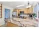 Bright kitchen features stainless steel appliances, granite countertops, and light wood cabinetry with a view to another room at 7075 Welch Ct, Arvada, CO 80004