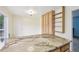 Open kitchen space with granite countertop, light wood cabinetry with a large pantry, and a view to the back patio at 7075 Welch Ct, Arvada, CO 80004